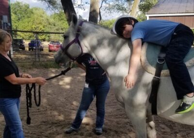 child laying on horse
